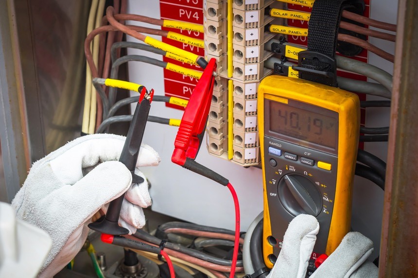 Electrical testing using a multimeter at a switchboard